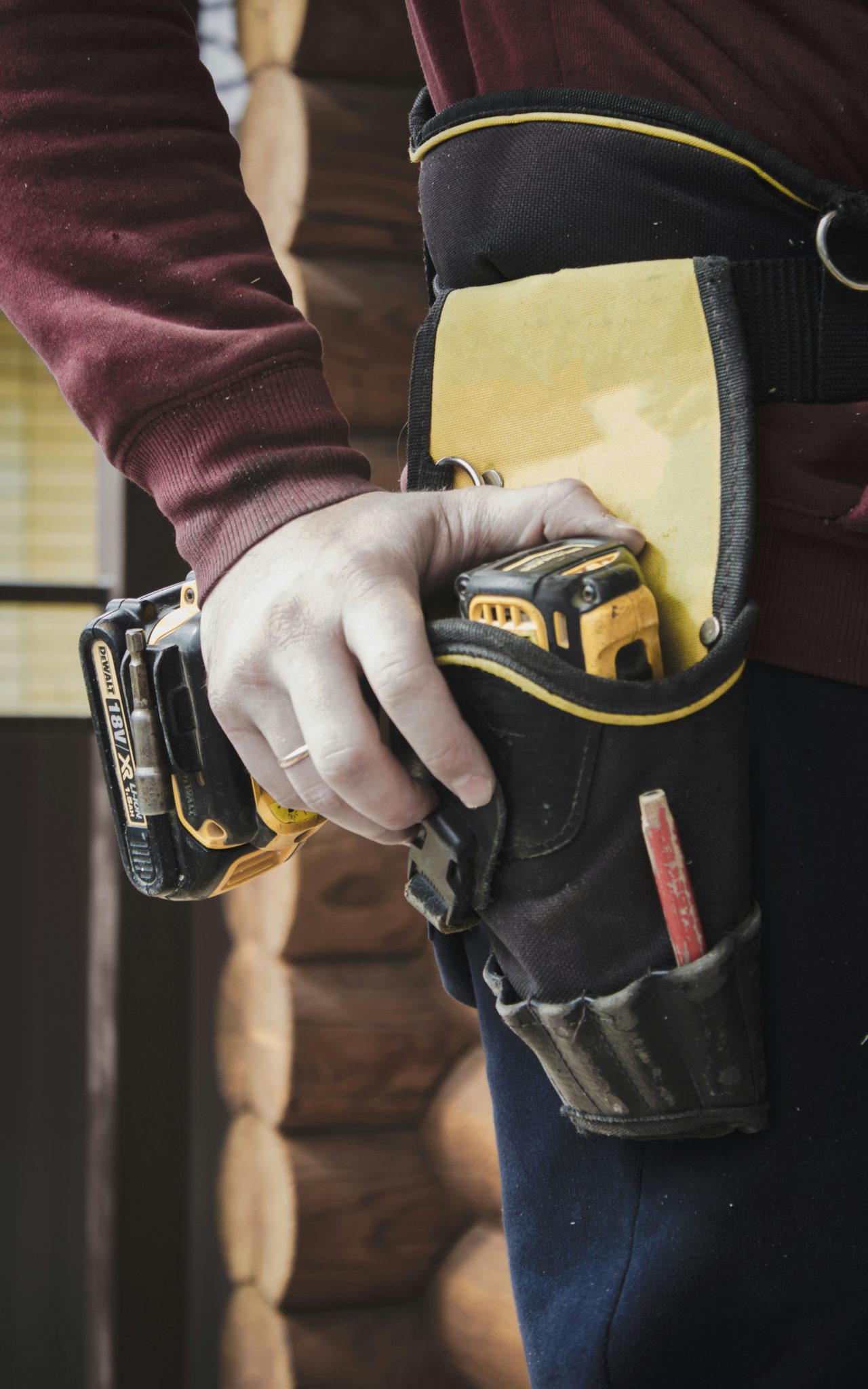 Image of a BAX Electric Electrician with a hand on their tool belt.